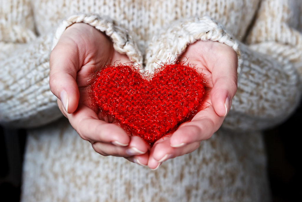 Knitted heart held in hands