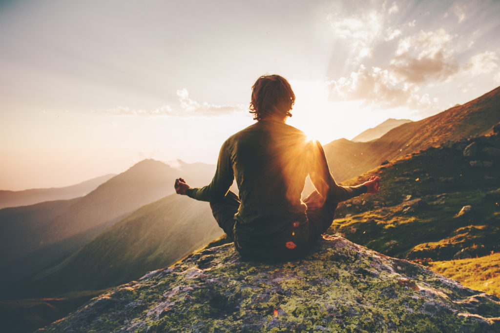 Meditation and relaxing on top of a mountain